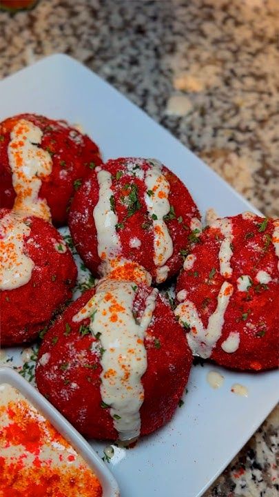 some food is on a white plate with sauces and seasoning next to it