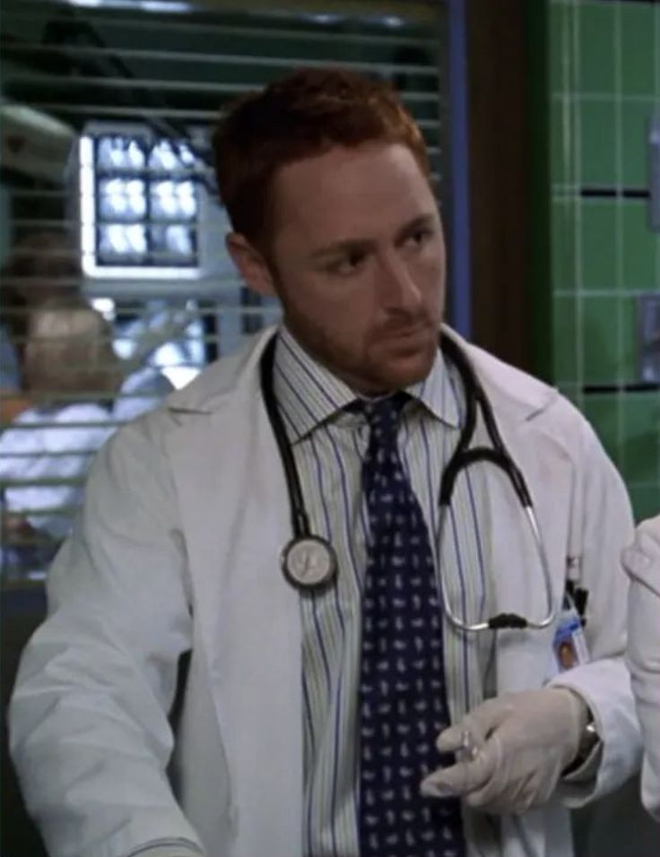 two doctors in white coats and ties standing next to each other