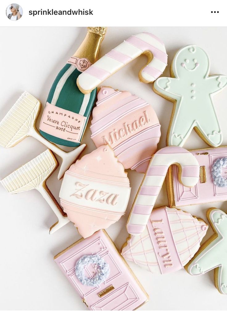 decorated cookies are arranged on a white surface