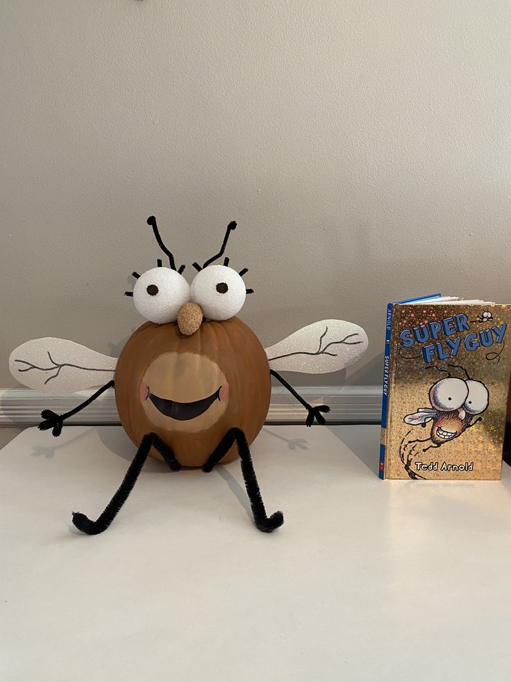 two books and a toy sitting on top of a white table next to each other