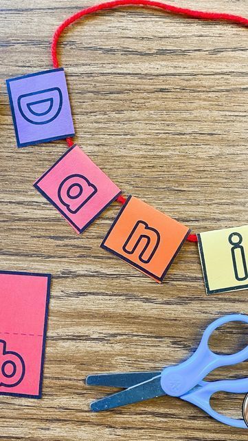 scissors and paper cut out to spell out the word social media on a wooden table