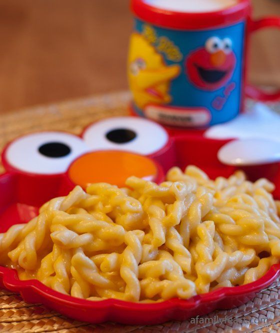 sesame street macaroni and cheese with elmo the cookie monster mug in the background