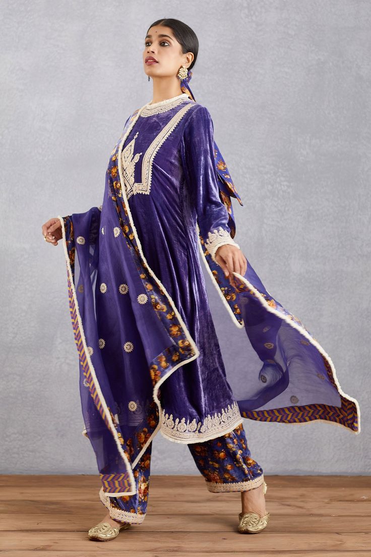 Amethyst purple flared long kurta with placement floral motif work. Comes with printed salwar and fringe border dupatta.
Component: 3
Embroidered, Printed
Neckline: Round
Sleeve Length: Full
Fabric: Kurta and Salwar: Velvet, cotton silk, voile; Dupatta: Pure silk Organza, velvet, cotton silk
Color: Purple
Fringe border
Back keyhole
 - Aza Fashions Purple Floor-length Traditional Wear For Navratri, Purple Palazzo Set With Dori Work For Eid, Unstitched Purple Palazzo Set For Navratri, Fitted Purple Embroidered Palazzo Set, Bollywood Style Purple Palazzo Set With Dupatta, Purple Palazzo Set With Zari Work For Navratri, Bollywood Purple Palazzo Set For Diwali, Purple Bollywood Palazzo Set With Dupatta, Semi-stitched Purple Palazzo Set For Eid