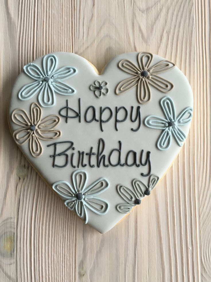 a heart shaped cookie with the words happy birthday written on it