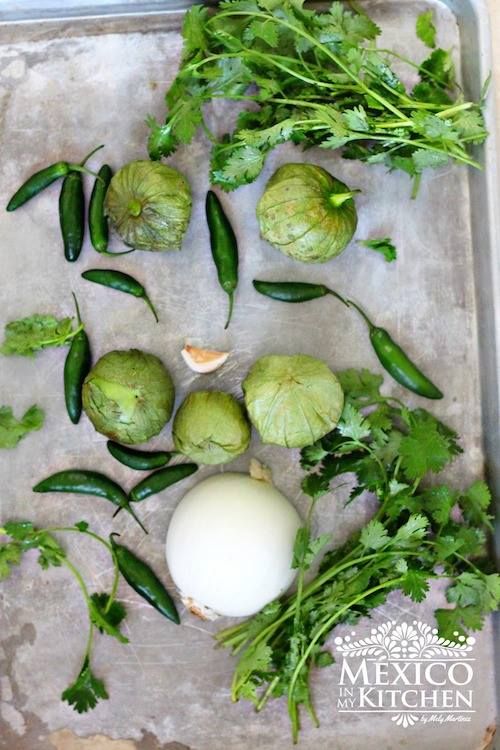 some green vegetables are laying on a baking sheet and ready to be cooked in the oven