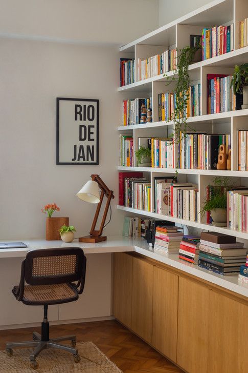 a home office with lots of books on the shelves