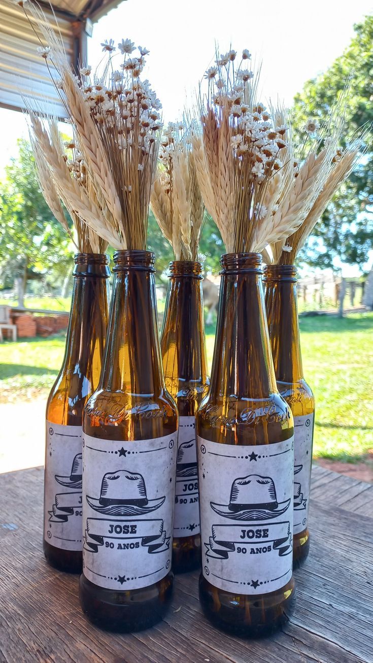 three brown bottles filled with beer sitting on top of a wooden table