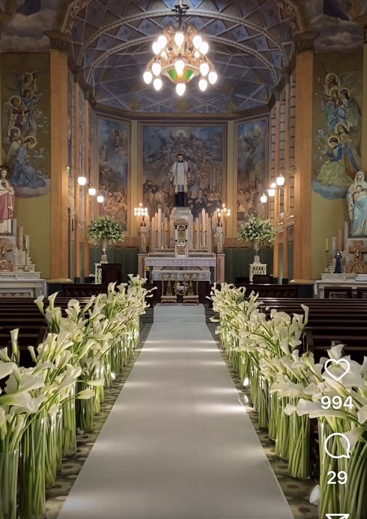 the aisle is lined with flowers and candles