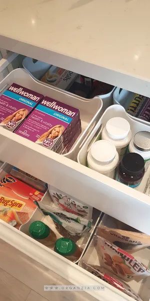 an open refrigerator door with food and condiments on the bottom shelf in it