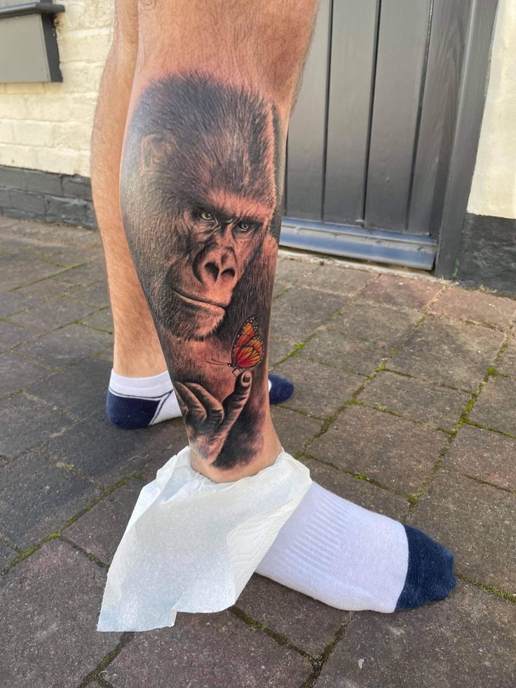 a man's leg with a gorilla tattoo on it