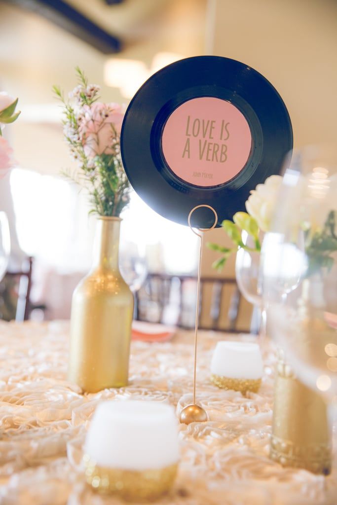 a table topped with vases filled with flowers and candles on top of a table