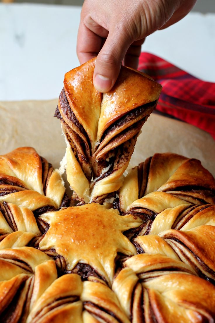 a person dipping some kind of pastry into it