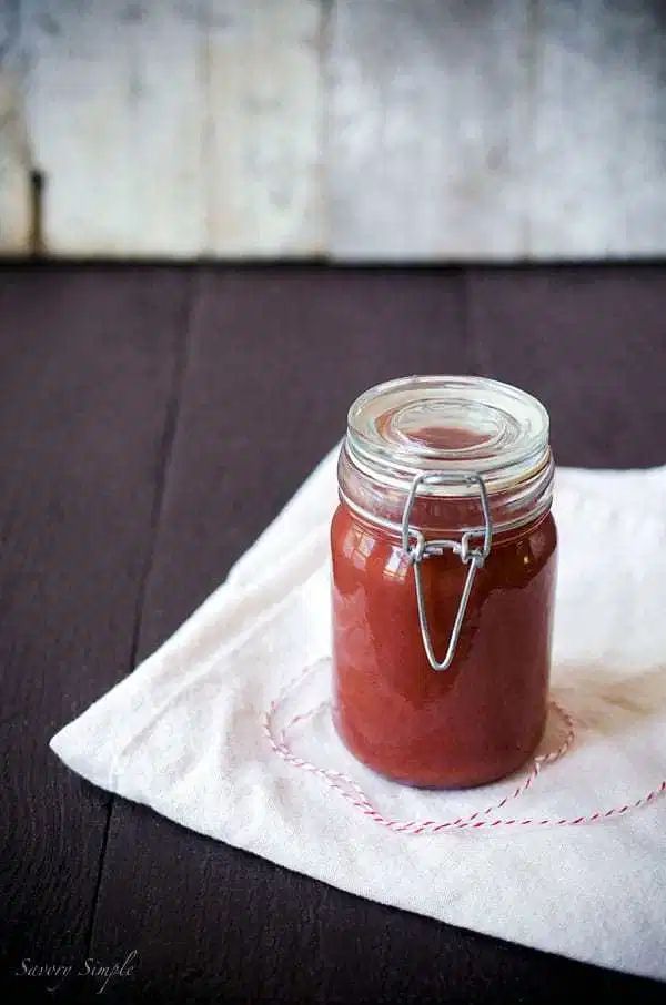 a glass jar filled with liquid sitting on top of a white napkin