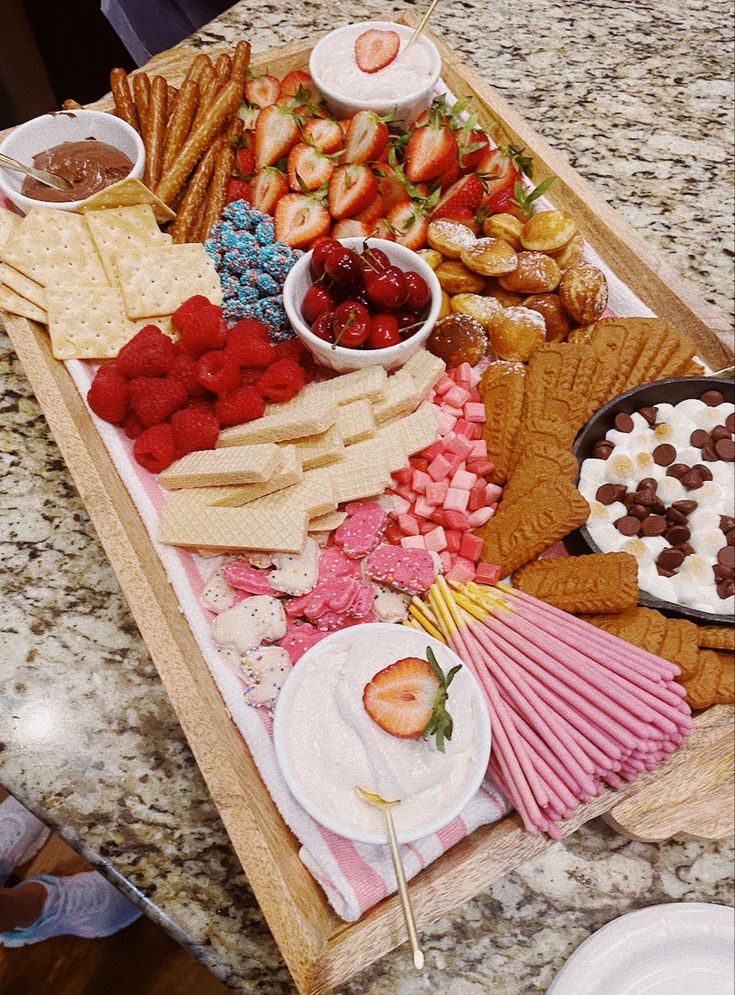 a tray full of snacks and desserts on a table