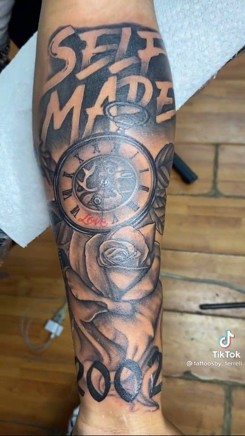 a man with a tattoo on his arm that reads self made and has scissors in it