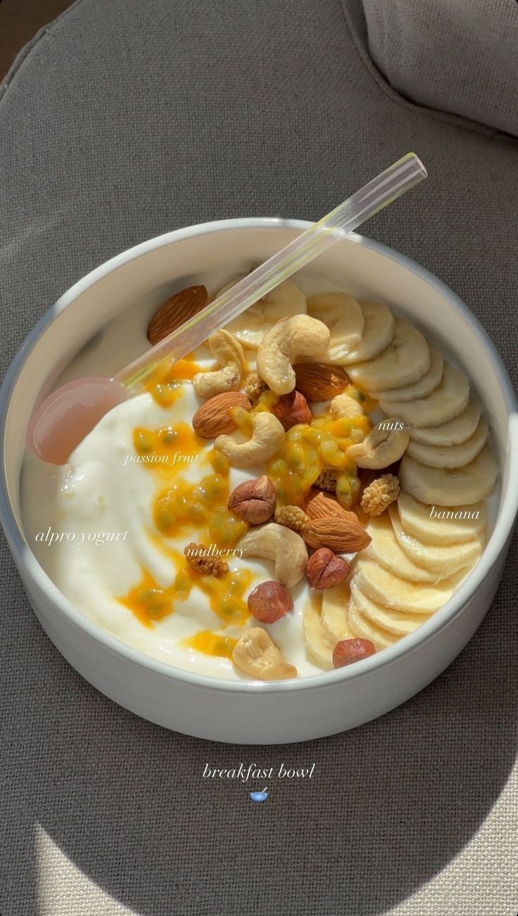 a bowl filled with cereal and nuts on top of a table