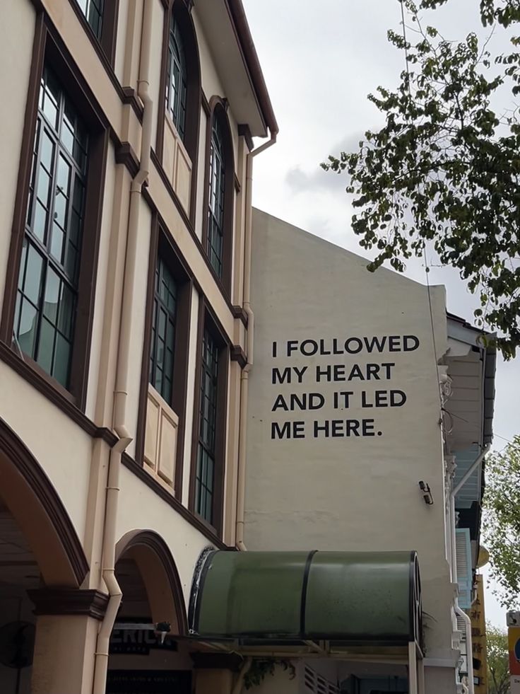 a sign on the side of a building that says i followed my heart and it led me here