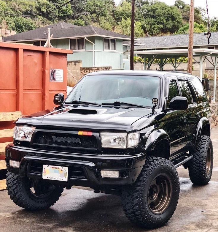 a black truck parked in front of a building