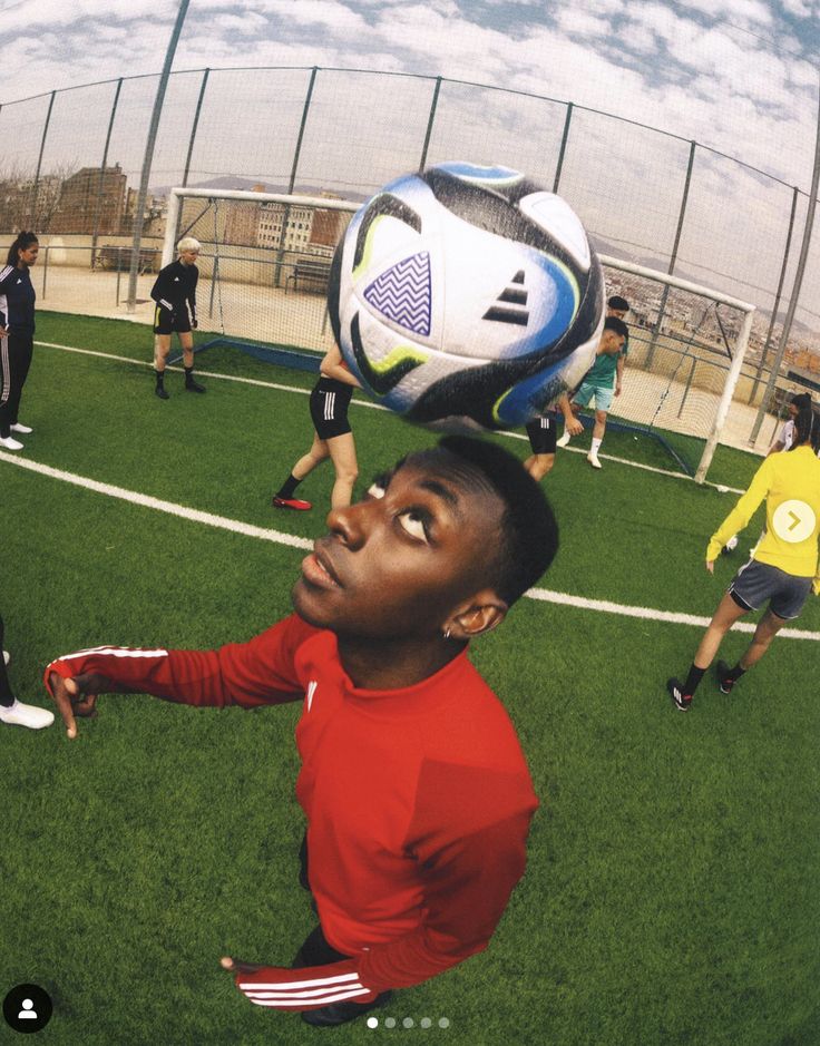 a young man is playing soccer on the field