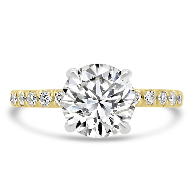 a yellow and white gold engagement ring with diamonds on the band, set in 18k gold