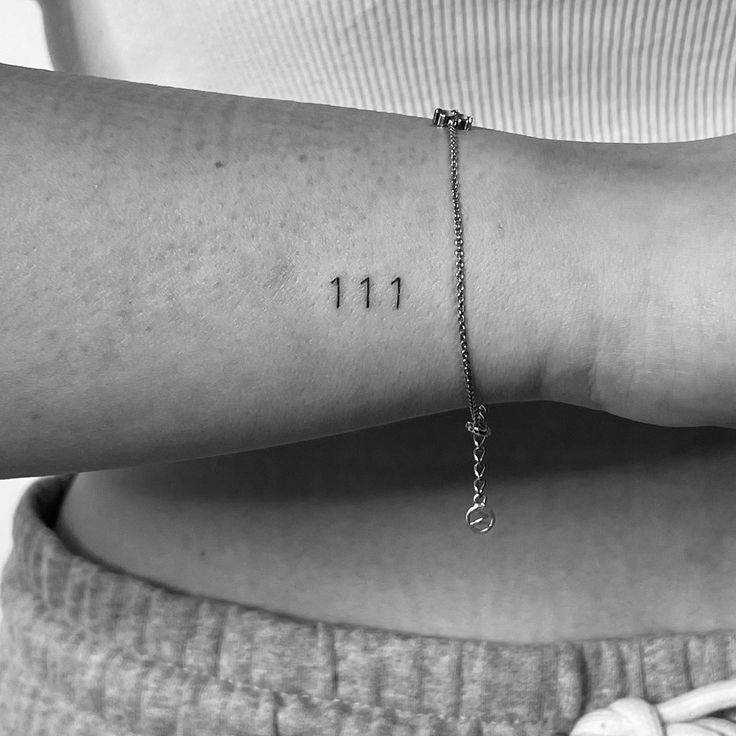 a woman's arm with the number 11 on it, and three small numbers