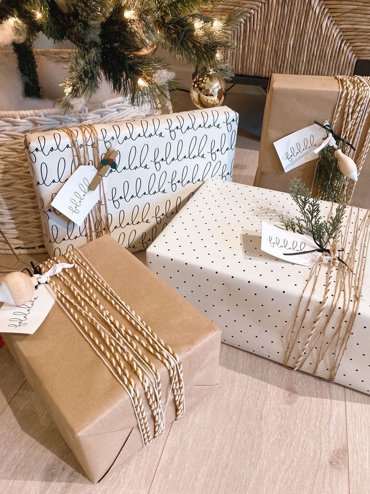 presents wrapped in brown paper and tied with twine on the floor next to a christmas tree