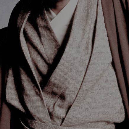 a black and white photo of a man wearing a robe