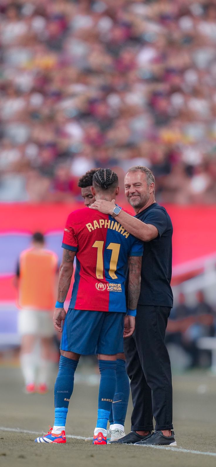 two soccer players are embracing each other on the field