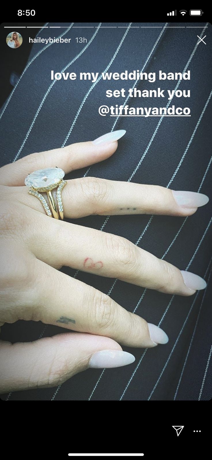 a woman's hand with two wedding bands on her ring and the words i love my wedding band set thank you