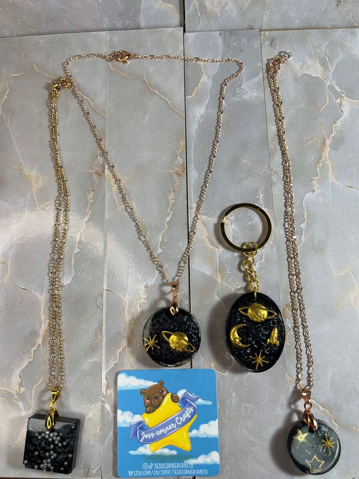 These are really cute resin pendants Black Resin Dangle Jewelry, Cute Black Jewelry With Charms, Cute Handmade Black Necklaces, Cute Handmade Black Necklace, Unique Resin Pendant Necklaces, Handmade Gold Resin Necklaces, Unique Resin Pendant Necklace, Nickel-free Resin Pendant Jewelry, Spiritual Gold Jewelry With Resin