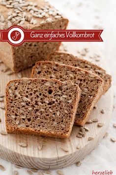 the bread is sliced and ready to be eaten on the table with seeds around it