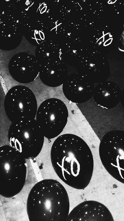 black balloons with white numbers are on the ground