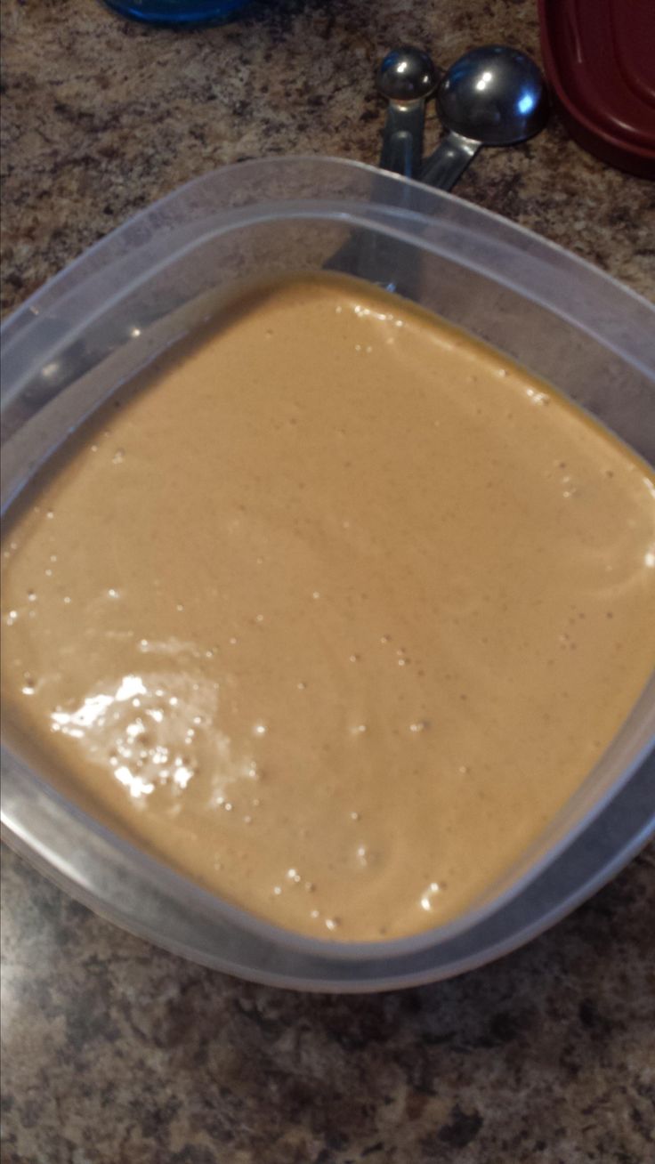 a container filled with batter sitting on top of a counter