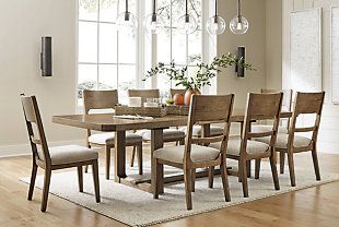 a dining room table and chairs in front of a window with an area rug on the floor