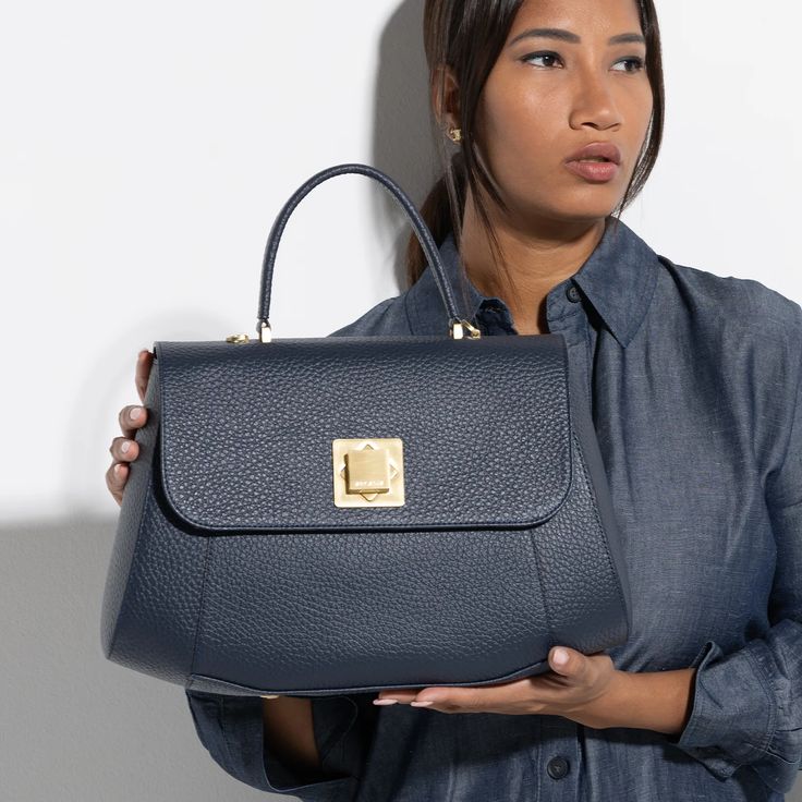 The Arcadia Bernadette is a satchel with geometric and sharp lines. It’s elegant and classy thanks to the macro front turn lock. It comes with a sholder strap for an extra comfort. Luxury Satchel With Fold Over Clasp And Double Handle, Office Flap Bag With Palladium Hardware And Top Handle, Office Flap Bag With Top Handle And Palladium Hardware, Luxury Double Handle Shoulder Bag With Fold Over Clasp, Luxury Everyday Shoulder Bag With Turn-lock Closure, Modern Business Satchel With Fold Over Clasp, Chic Office Satchel With Turn-lock Closure, Luxury Satchel Flap Bag With Palladium Hardware, Designer Satchel With Fold Over Clasp And Top Handle