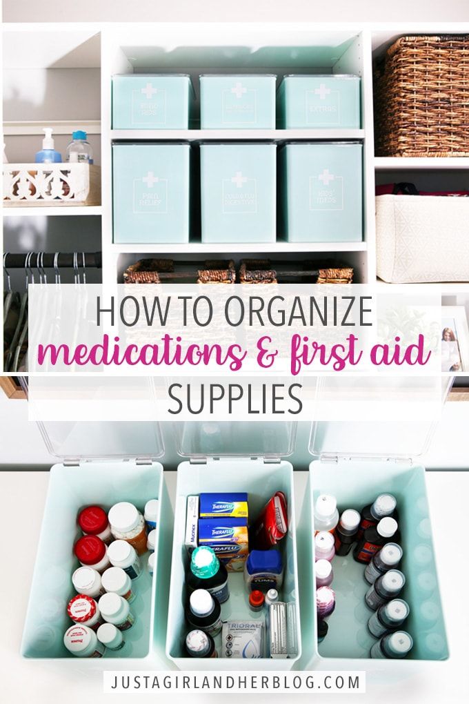 an organized cabinet with containers and supplies in the bottom, labeled how to organize medications & first aid supplies