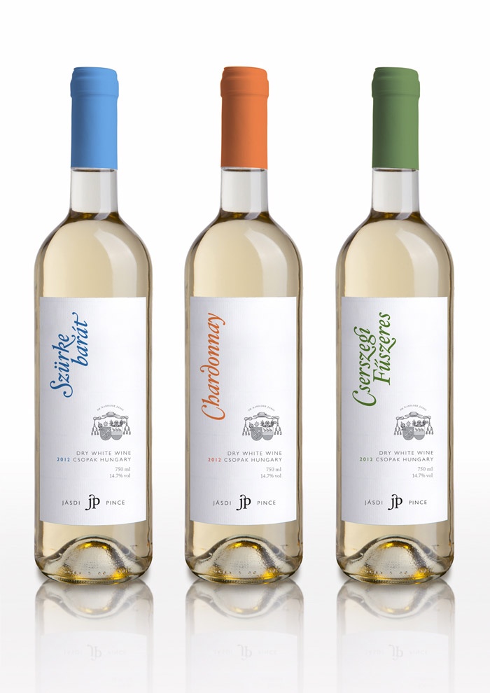 three bottles of wine are shown on a white surface