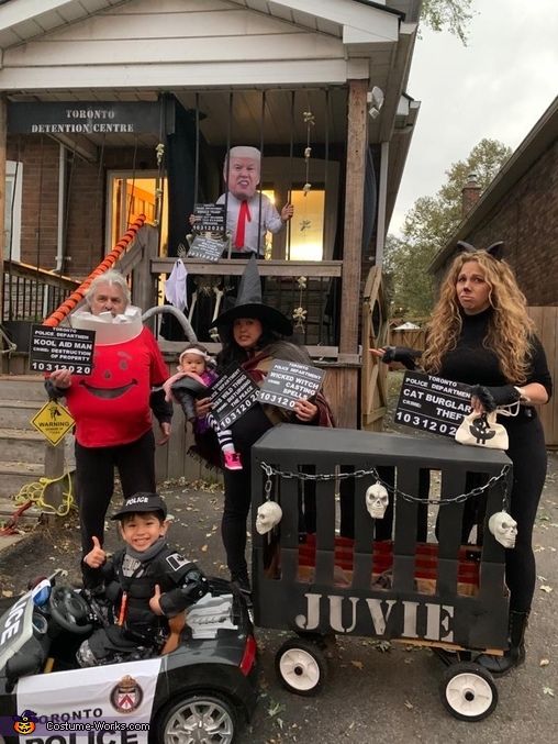 a group of people dressed up in costumes and holding signs with the same person on them