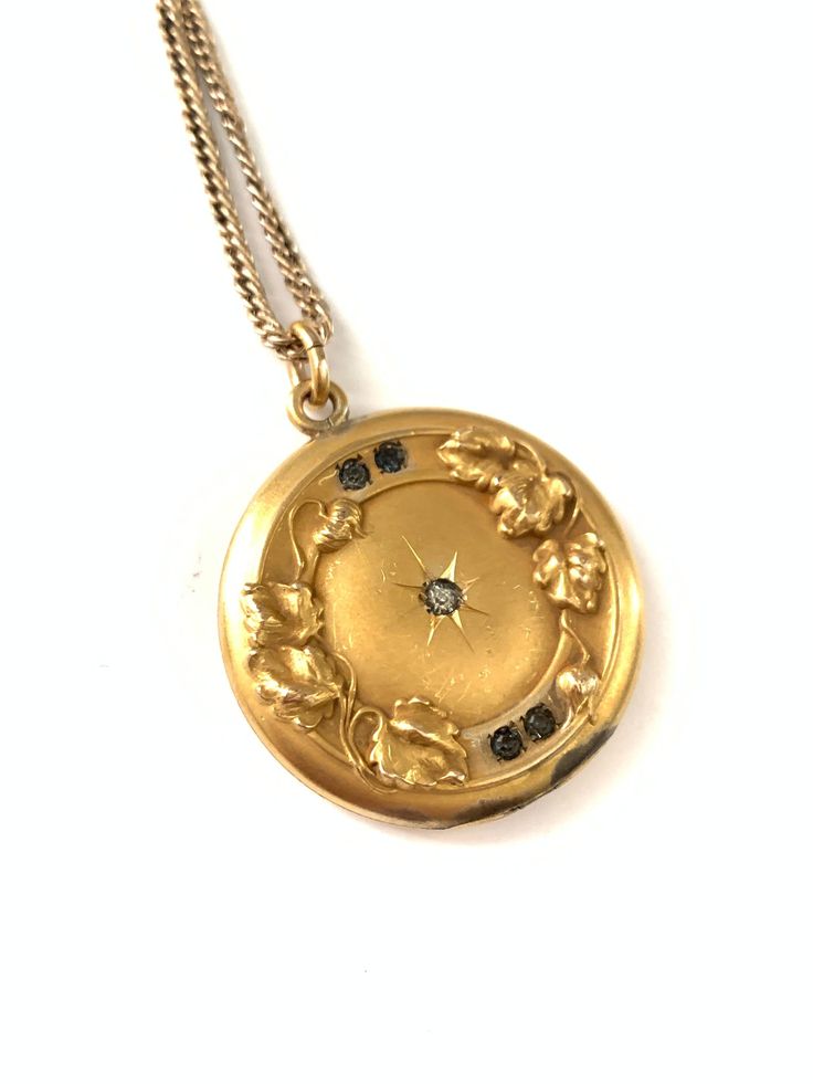 "Vintage 1911 Edwardian Gold Filled Starburst and Ivy Locket Pendant Bloom, Vintage Photo Locket Keepsake Jewelry, Gift for Her Stunning antique locket, with a starburst in the center encrusted with paste rhinestone in the center. Around the edges is a beautiful framed border with ivy growing along the sides.  The inside of the locket has both frames and covers still in tact and the back of the locket is engraved with initials that I can't make out but at the bottom it is engraved 1911.  The locket has a beautiful patina and some light wear to the metal on the cover. I think it adds character but please take a look at all pictures closely for yourself.  The locket measures 1 1/8\" x 1 1/4\" and closes securely and the chain measures 20\". The clasp on the chain is very old and does get stu Engraved 1911, Gold Coin Jewelry, Heirloom Jewelry, Vintage Pendant Necklace, Antique Locket, Vintage Fans, Heirlooms Jewelry, Large Jewelry, Photo Locket