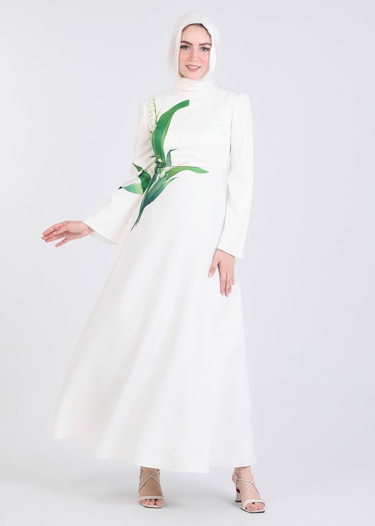 Step into elegance with our Lily-Inspired Flared Sleeve Maxi Dress, crafted from durable crepe. This ivory-toned dress features a unique lily floral motif on the bodice, evoking a sense of nature-inspired beauty. The flowing bell sleeves add a touch of sophistication, perfect for formal occasions or chic daytime wear. The full-length design ensures modest coverage while maintaining a graceful silhouette. Elevate your wardrobe with this timeless piece that seamlessly blends luxury and comfort.