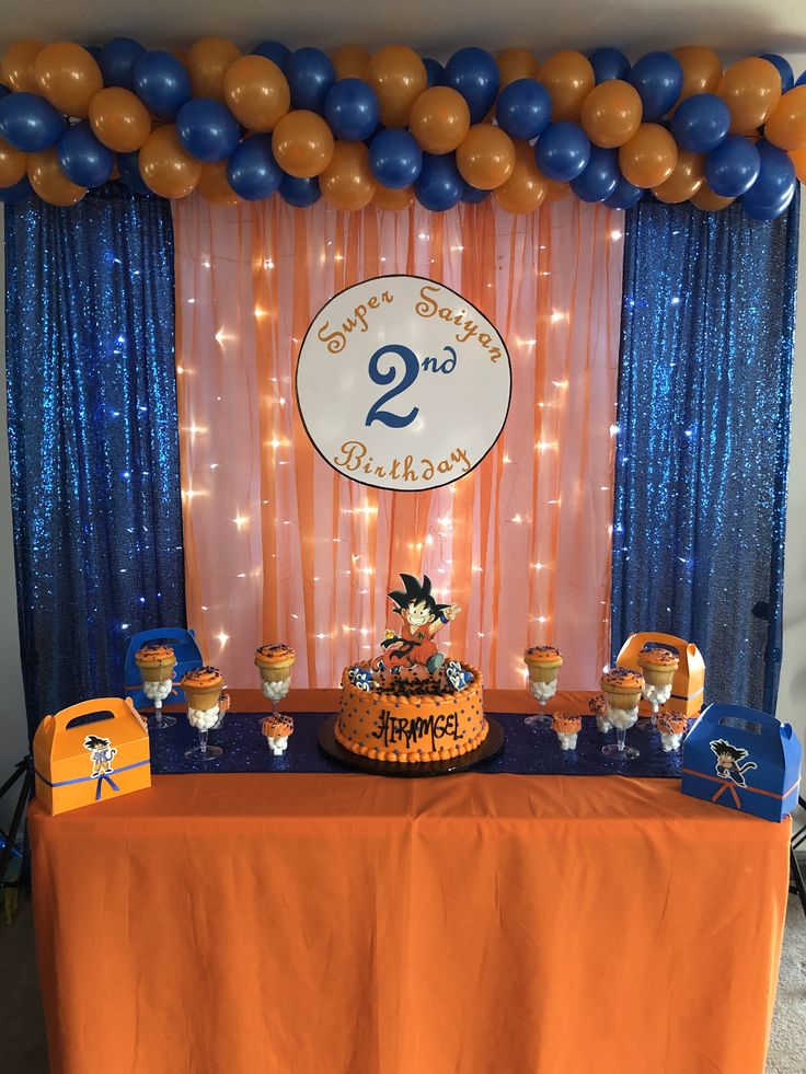 an orange table topped with a cake and balloons