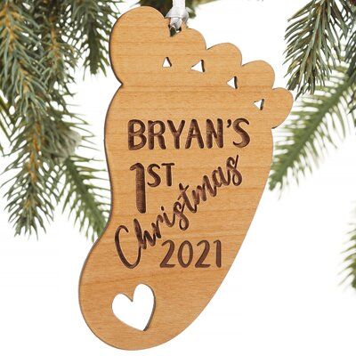 a wooden ornament hanging from a christmas tree with the name ryan's 1st christmas