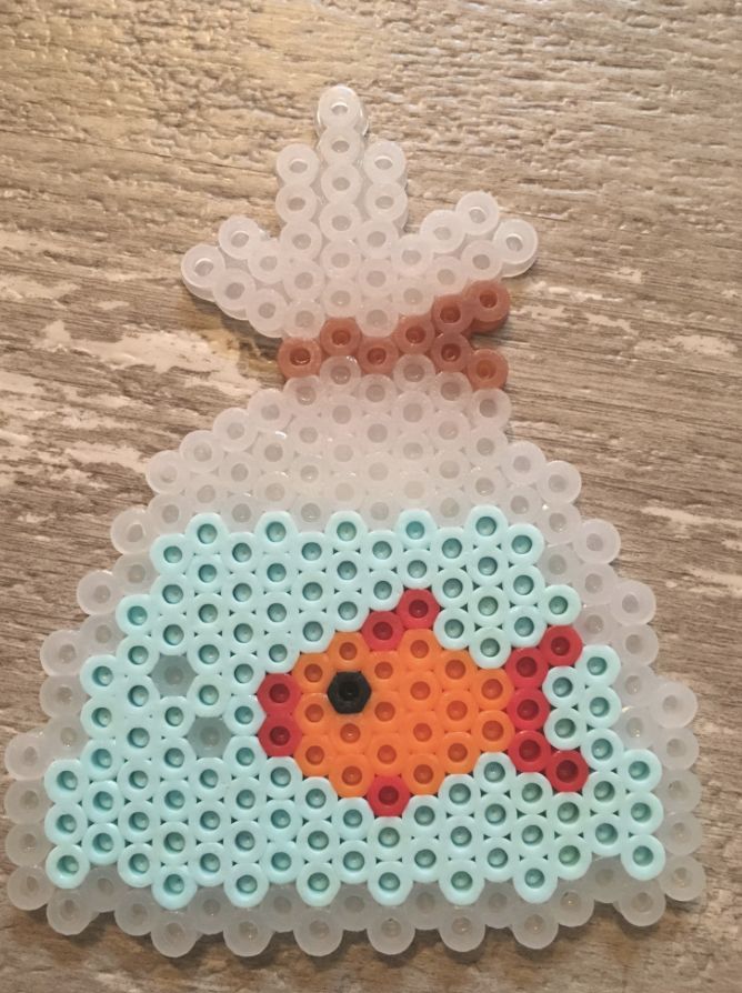 an ornament made out of plastic beads with a fish in the water on it