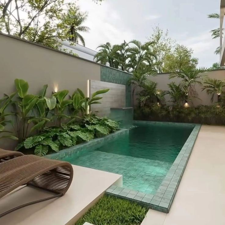 an outdoor swimming pool surrounded by greenery