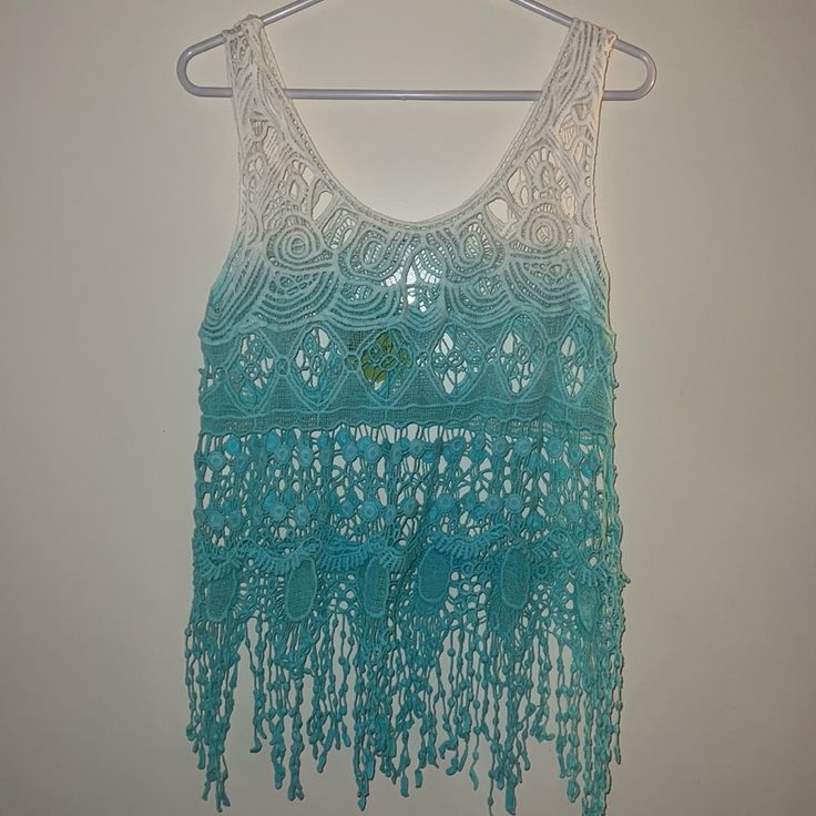 Breeze Ever Small Ombr Crochet Top Sleeveless Ombre Crochet Top, White Sleeveless Crochet Top For Festival, Sleeveless Blue Lace Tops, Blue Lace Sleeveless Tops, Sleeveless Crochet Lace Top For Beach Cover-up, Blue Lace Tops For The Beach, White Sleeveless Crochet Top For Beachwear, White Bohemian Tank Top For Beach, Blue Sleeveless Tank Top For The Beach