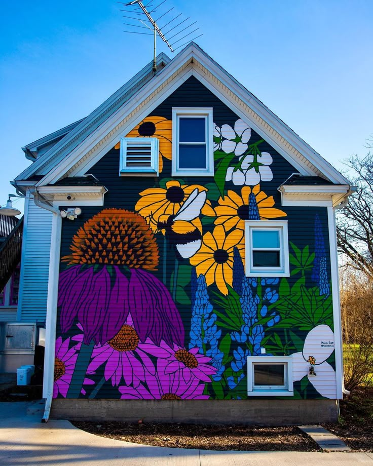 a house with flowers painted on the side