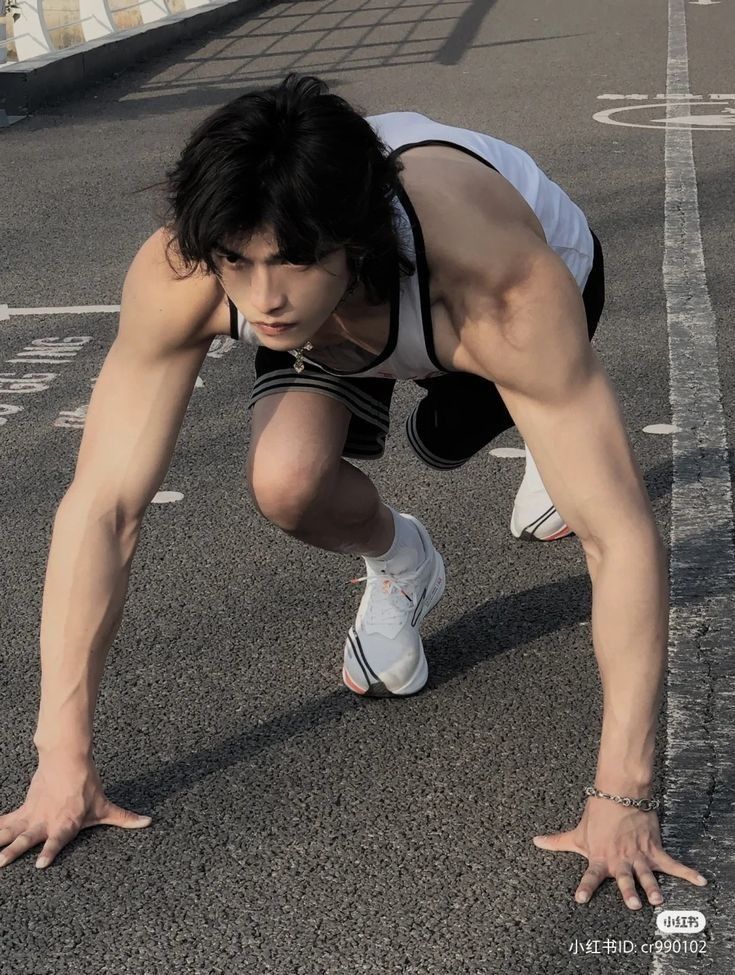 a man is doing push ups in the street