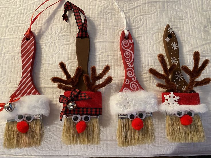 three christmas decorations made to look like santa's hats and reindeer noses hanging on a wall