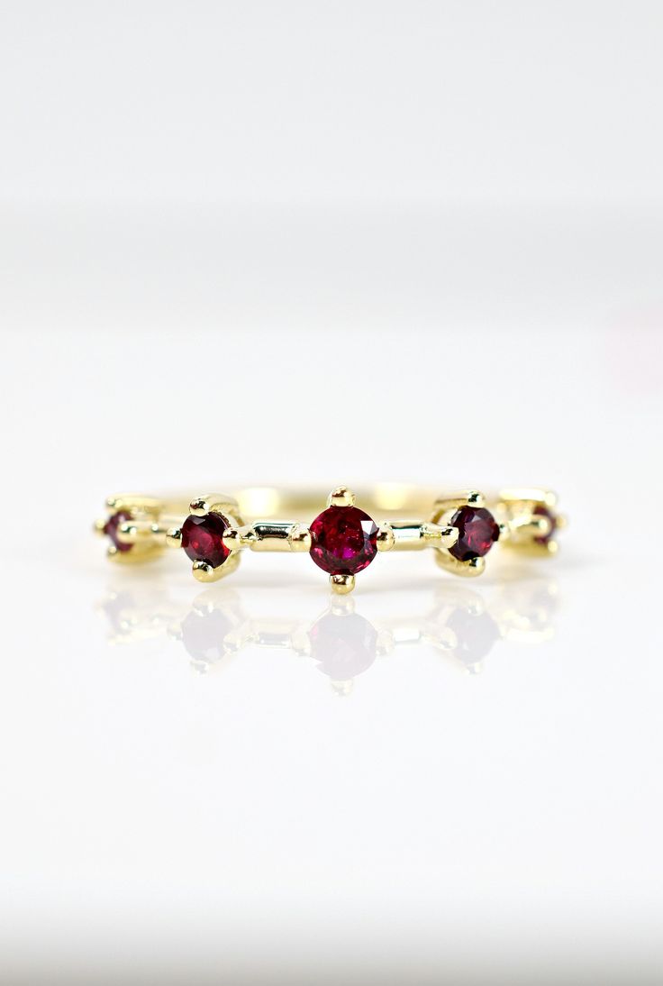 This striking ruby ring features AAA quality round cut rubies on 14K yellow gold. A unique statement piece to add to your collection. A wonderful alternative to a traditional wedding band. Ruby is also the July birthstone for all you July babies! Please drop your finger size in the notes section at checkout. Please be aware international buyers are responsible for duties and fees. Gold Stackable Ruby Ring, Ruby Half Eternity Round Ring In Fine Jewelry Style, Ruby Stackable Rings With Prong Setting, 14k Gold Ruby Half Eternity Ring, Formal Lab-created Ruby Ring With Round Band, Yellow Gold Ruby Ring With Round Cut Lab-created Ruby, Promise Ruby Ring, Yellow Gold Stackable Ruby Ring, Stackable Ruby Ring In 14k Gold With Round Band