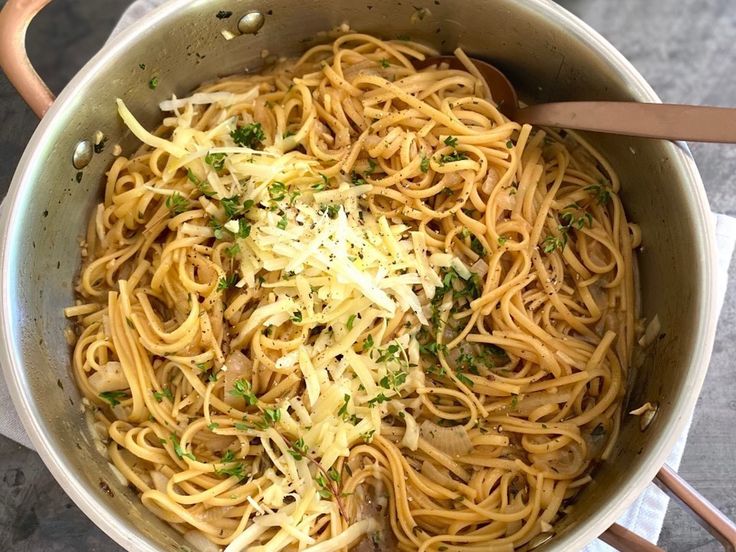 a pot filled with pasta and parmesan cheese